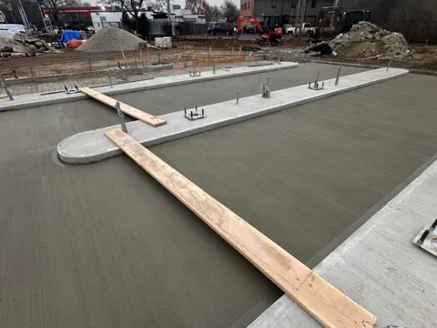 Screeding the pour. Executive Building Systems project.