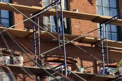 Façade repair from the swing stage, Peekskill, NY. Executive Building Systems project.