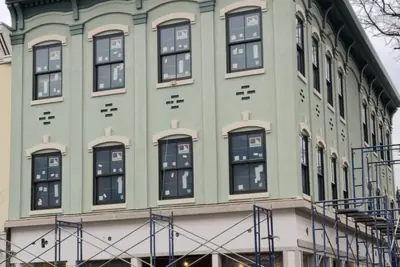 Corner elevation under scaffold. Executive Building Systems project.