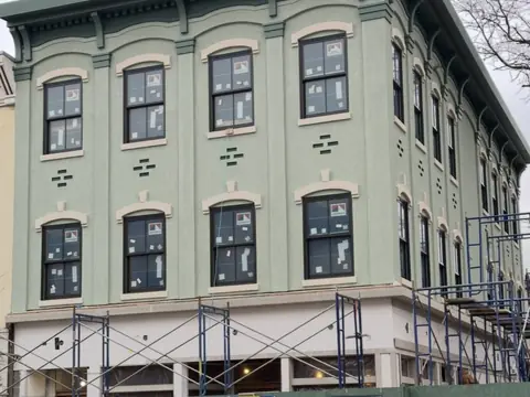 Corner elevation under scaffold. Executive Building Systems project.