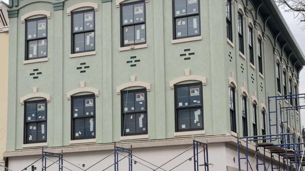 Corner elevation under scaffold. Executive Building Systems project.