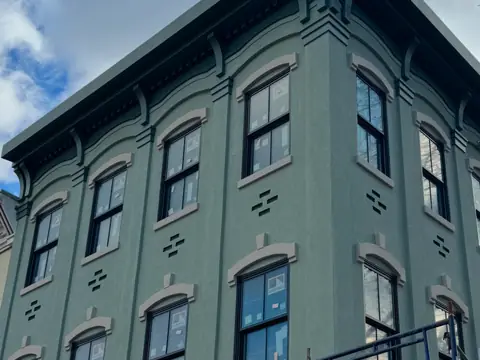 Restored façade, scaffold struck. Executive Building Systems project.