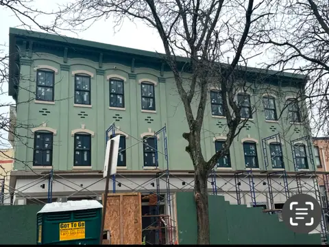 Façade restoration under pipe scaffold. Executive Building Systems project.
