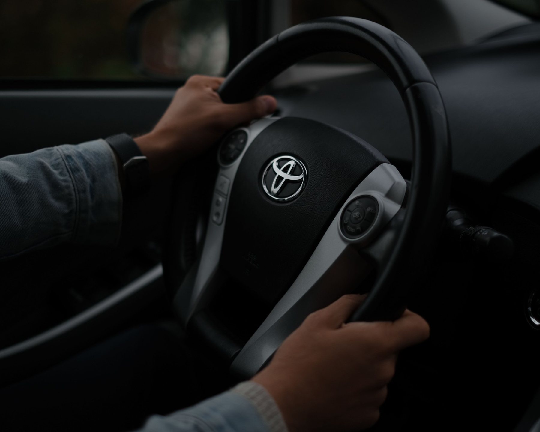 Driver with both hands on the steering wheel