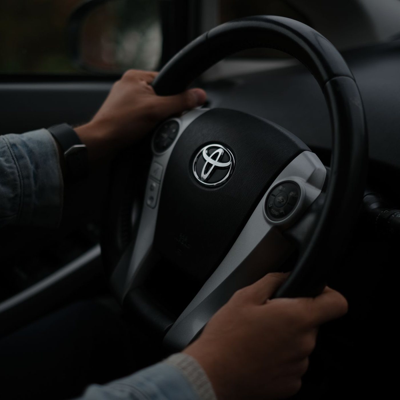 Hands on a steering wheel, close up