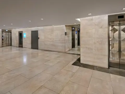 Elevator lobby in stone. Executive Building Systems project.
