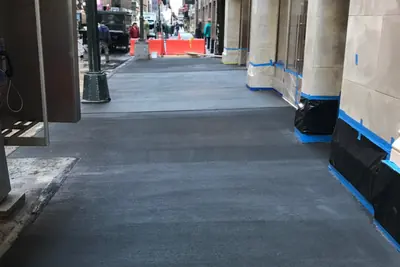 Sidewalk work under a shed, Midtown East, NYC. Executive Building Systems project.