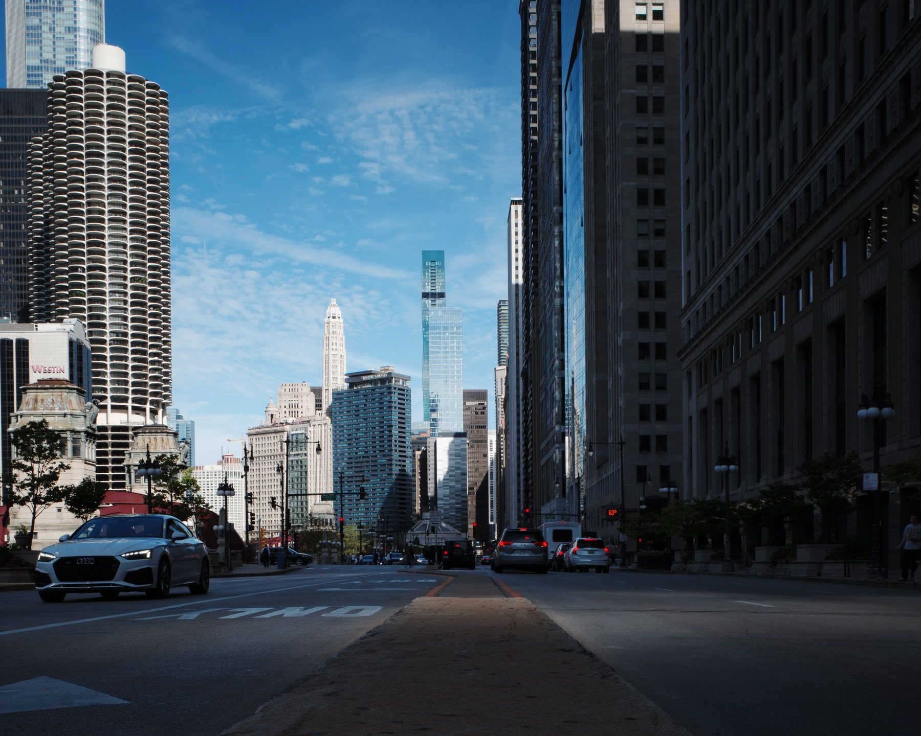 A downtown city street under a clear blue sky