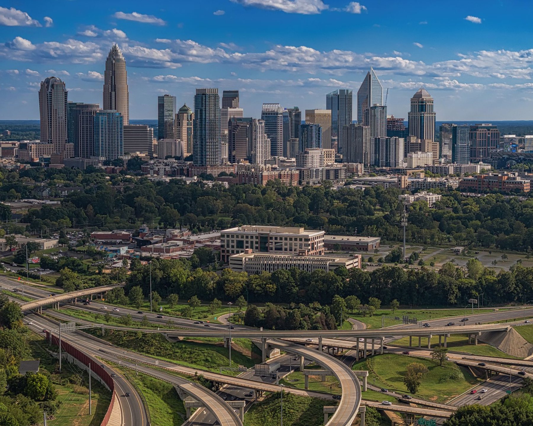 A city skyline with highways in summer sunshine
