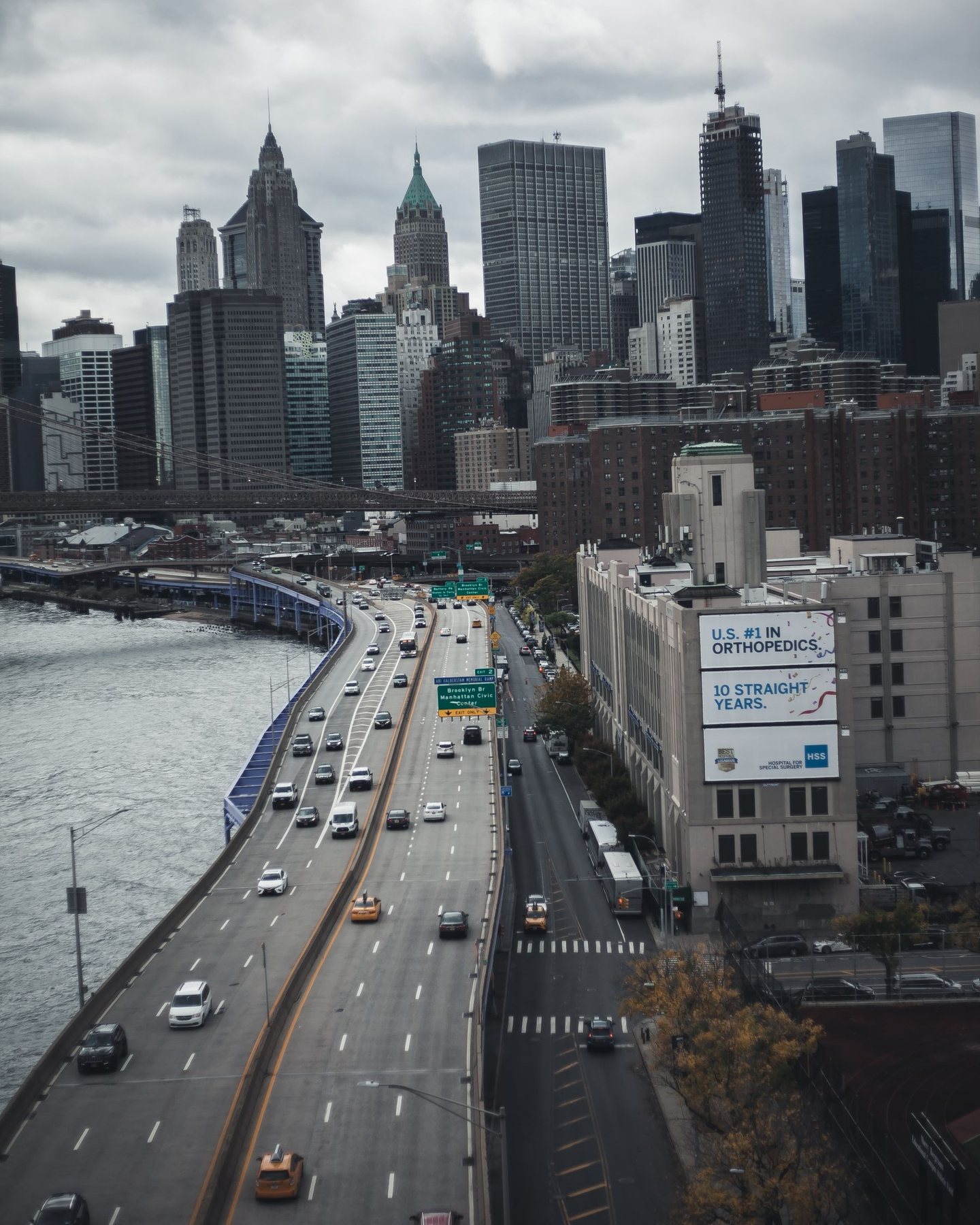 Manhattan from above, with traffic on the expressway beside the river
